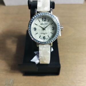 Woman's Silver and white watch with an aqua stone bezel